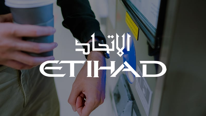 Etihad logo overlaying imagery of contactless payment.